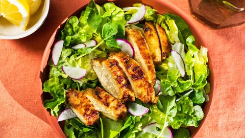 Cultivated chicken made by Upside Foods, a cultivated meat company, rests atop a salad.