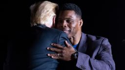 Former President Donald Trump hugs Herschel Walker.