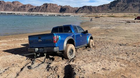 A truck is stuck in the muddy shoreline of Lake Mead.
