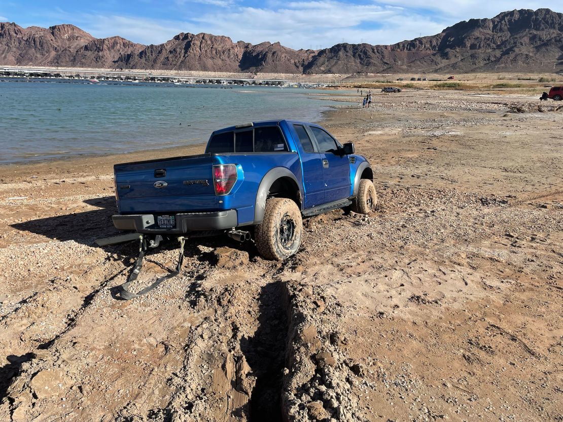 A truck is stuck in the muddy shoreline of Lake Mead.