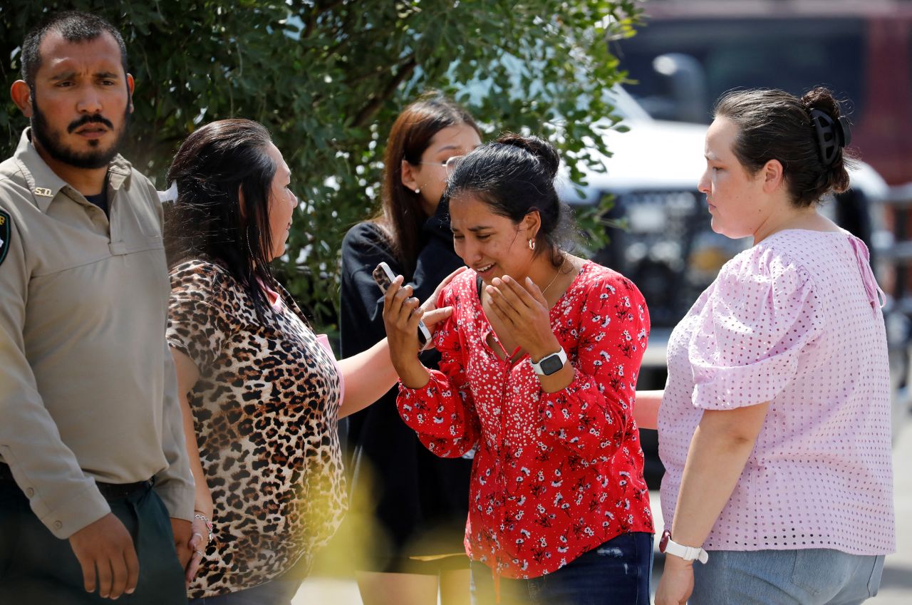 A woman reacts outside of the civic center in Uvalde.