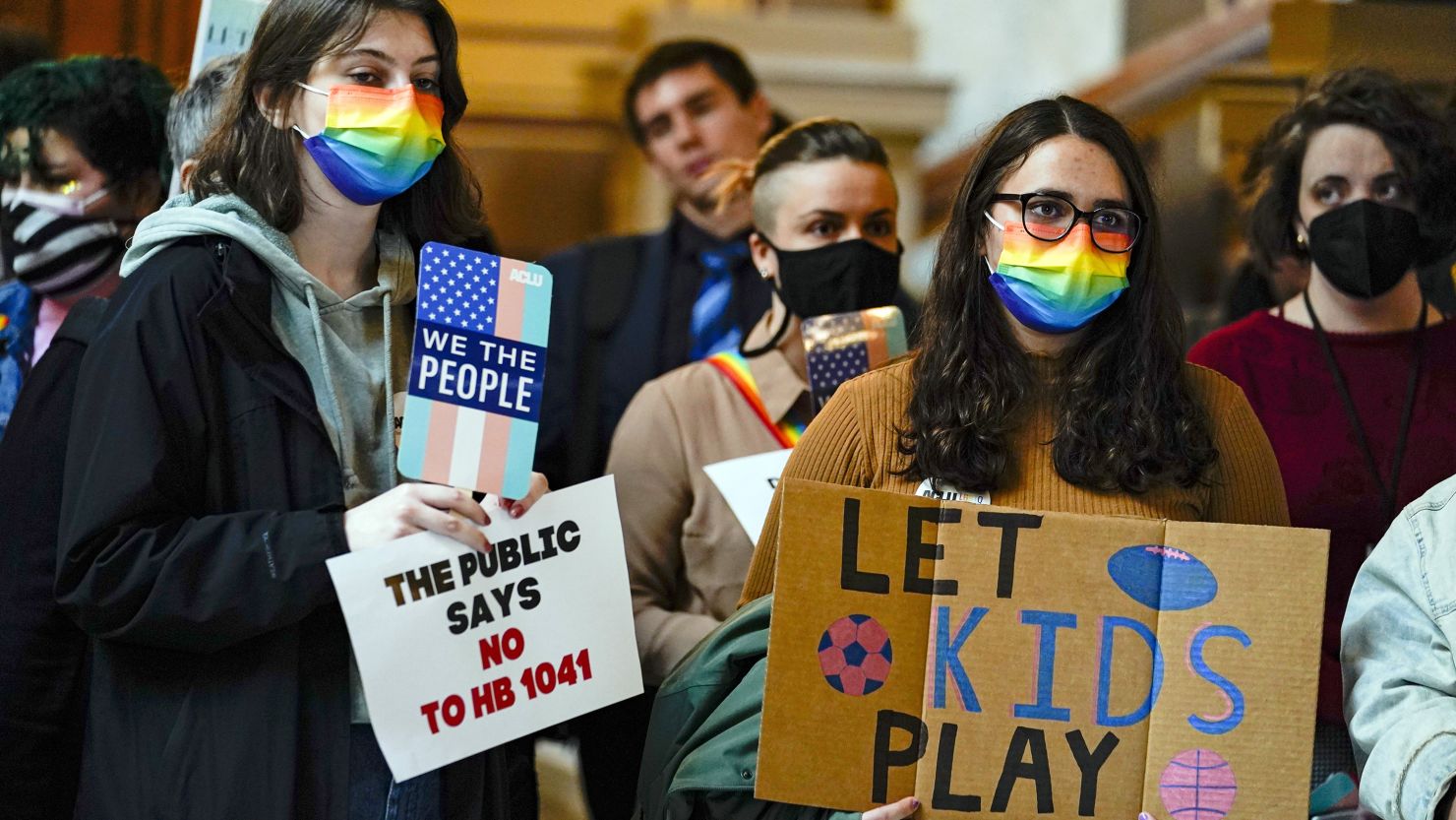 People gather to protest against HB1041, a bill to ban transgender women and girls from participating in school sports that match their gender identity, during a rally at the Statehouse in Indianapolis, Wednesday, Feb. 9, 2022. 