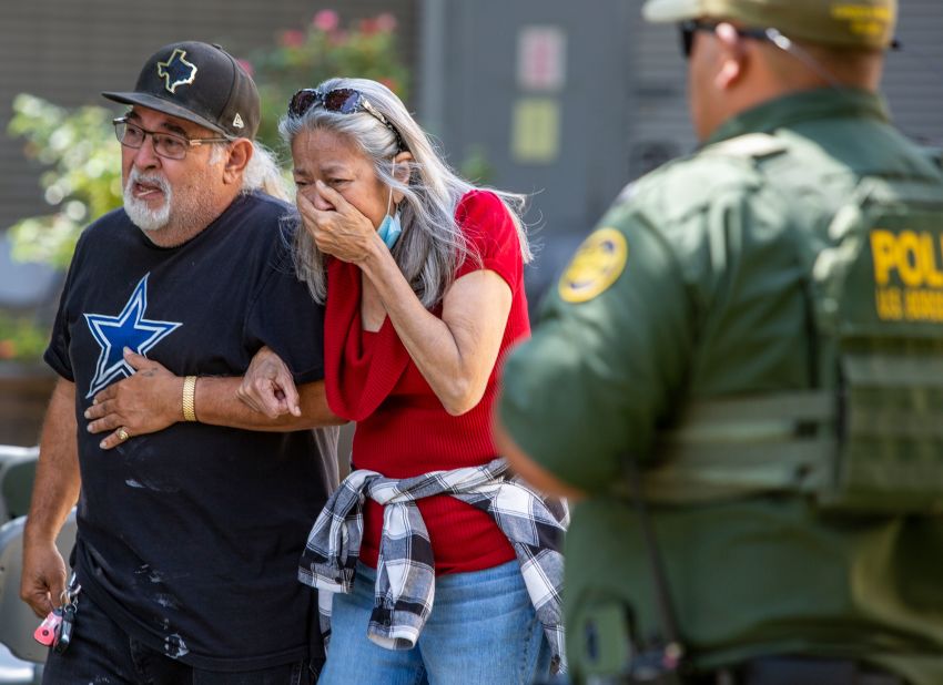 A woman cries as she leaves the civic center. 