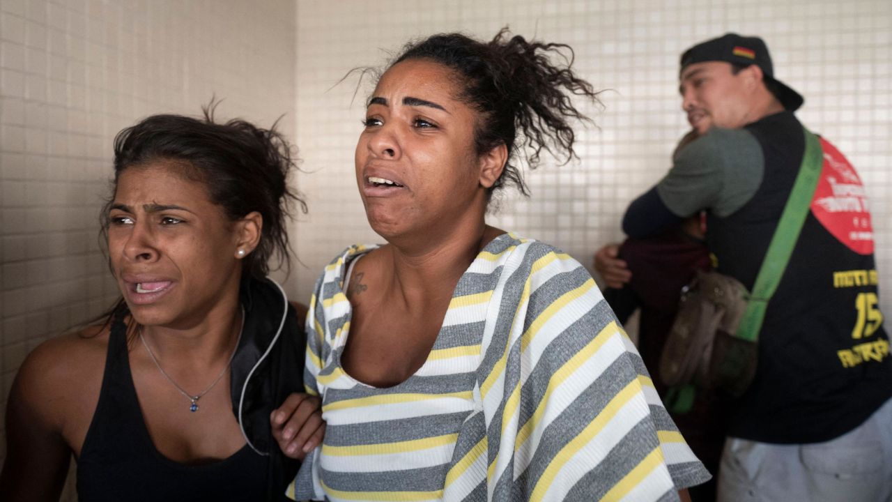 People react as victims arrive at the Getulio Vargas Hospital on May 24, 2022.