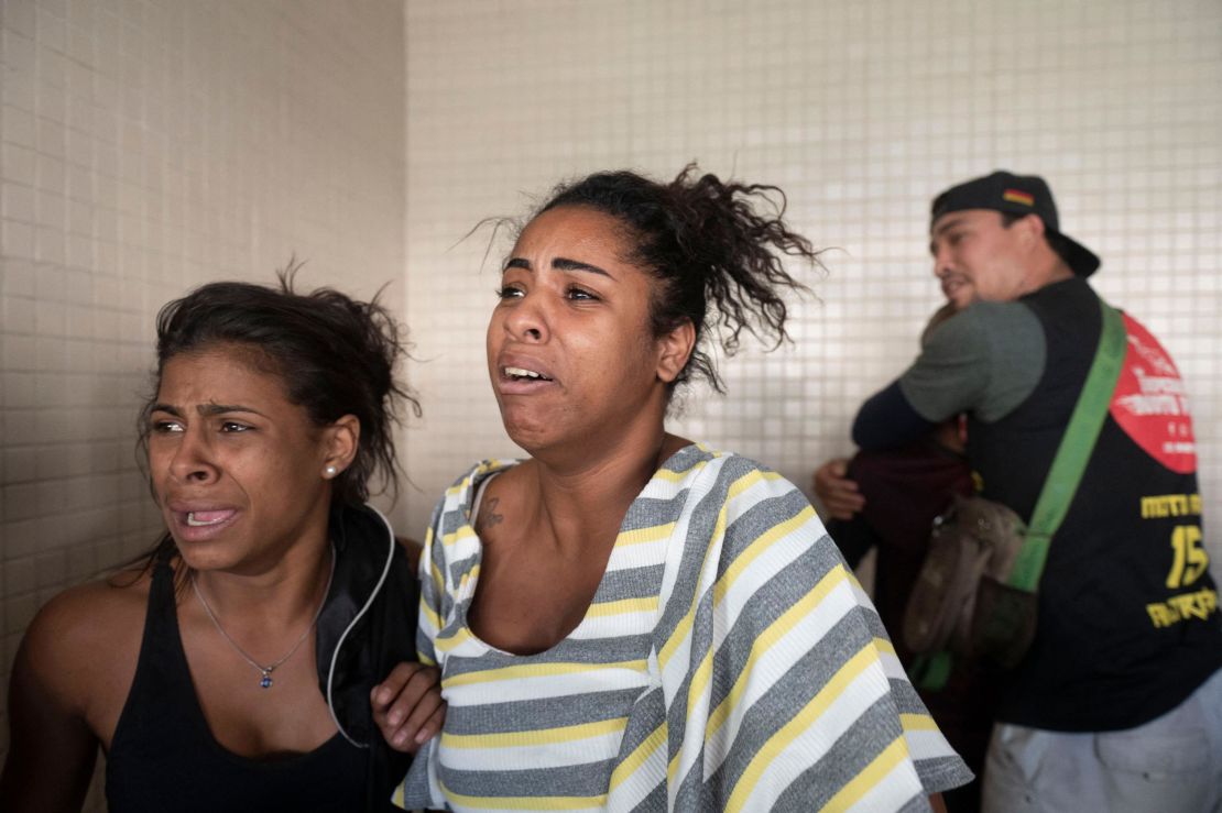 People react as victims arrive at the Getulio Vargas Hospital on May 24, 2022. 