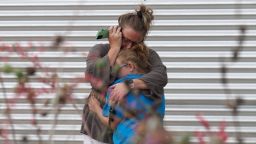 A woman cries and hugs a young girl while on the phone outside the Willie de Leon Civic Center where grief counseling will be offered in Uvalde, Texas, on May 24, 2022. - An 18-year-old gunman killed 14 children and a teacher at an elementary school in Texas on Tuesday, according to the state's governor, in the nation's deadliest school shooting in years. (Photo by allison dinner / AFP) (Photo by ALLISON DINNER/AFP via Getty Images)