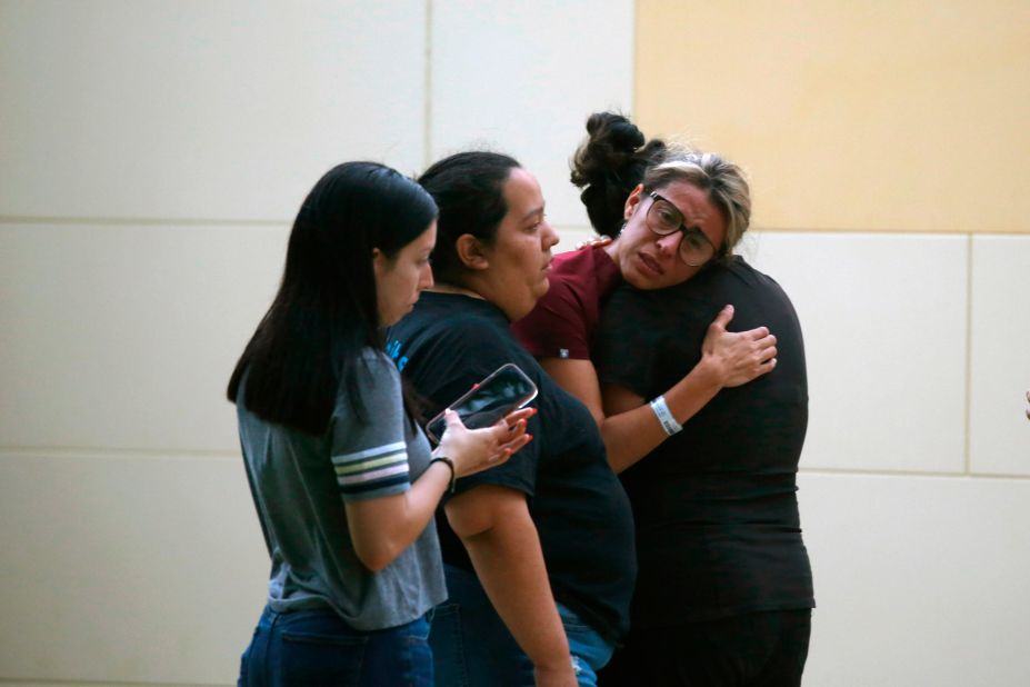 People comfort each other outside the civic center in Uvalde.