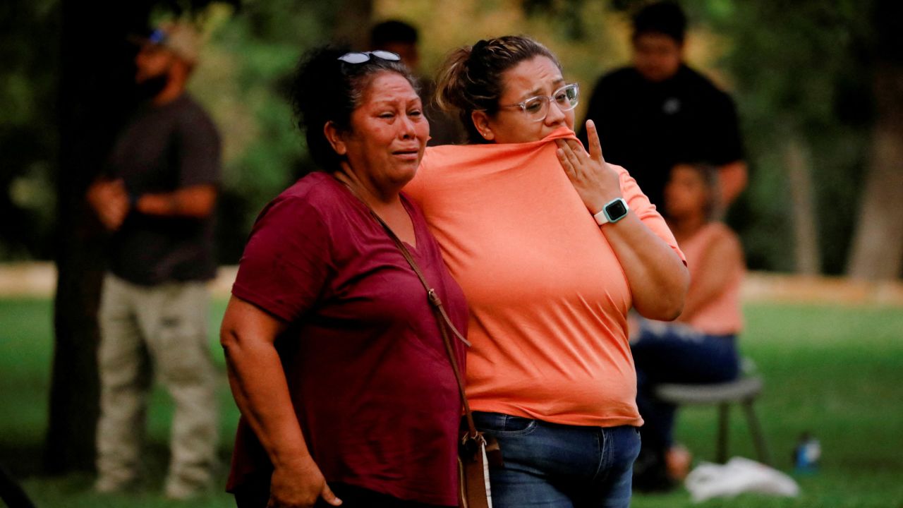 People gather outside a civic center after the shooting at nearby Robb Elementary School.