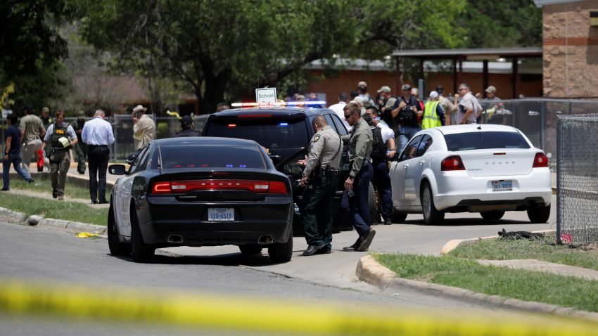 Law enforcement officers guard the scene of a shooting at Robb Elementary School in Uvalde, Texas, U.S. May 24, 2022.  REUTERS/Marco Bello