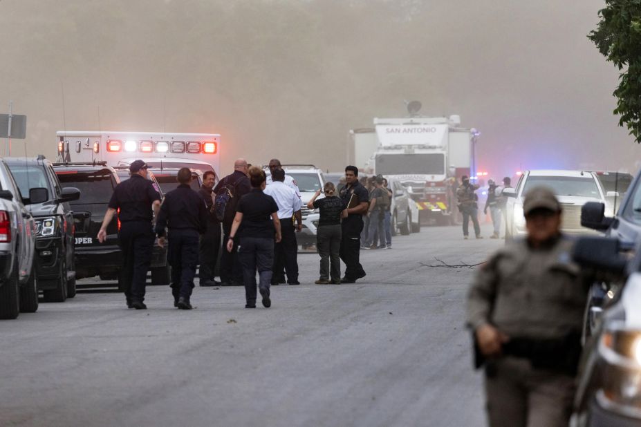 Law enforcement officials work the scene after the shooting on May 24.