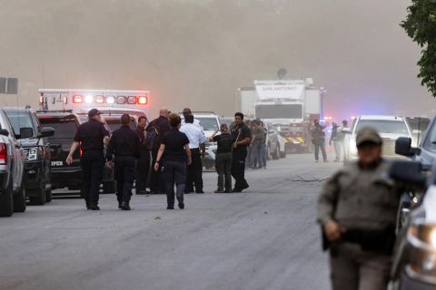 Law enforcement officials work the scene after the shooting on Tuesday.