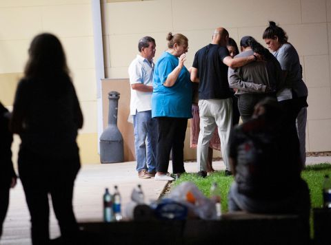 Members of City Church from San Antonio pray outside the civic center in Uvalde Tuesday night.