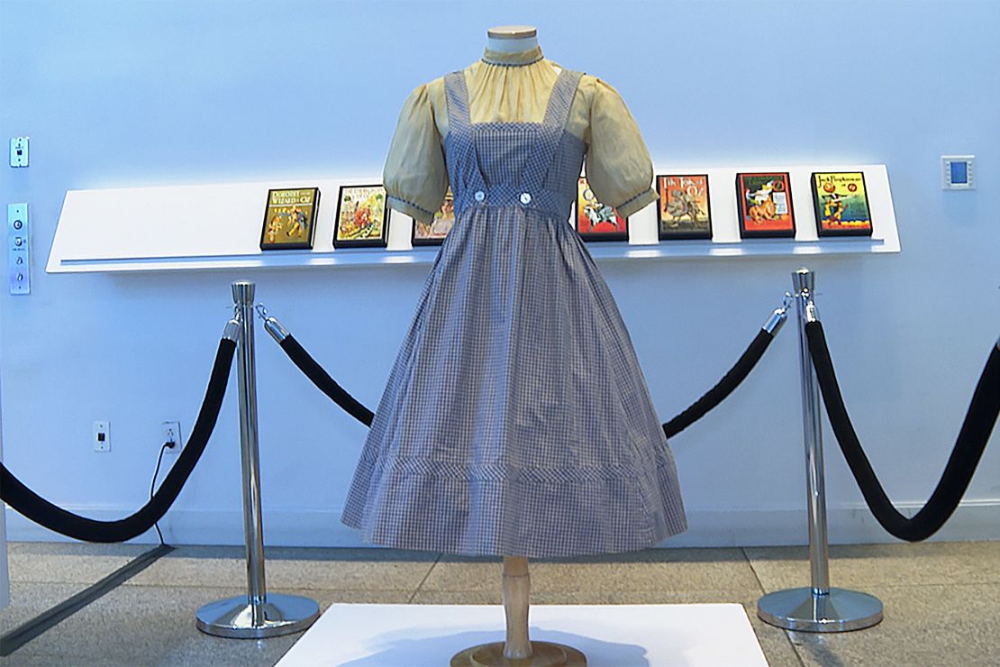 A blue and white checked gingham dress, worn by Judy Garland in the "Wizard of Oz," hangs on display, Monday, April 25, 2022, at Bonhams in New York.