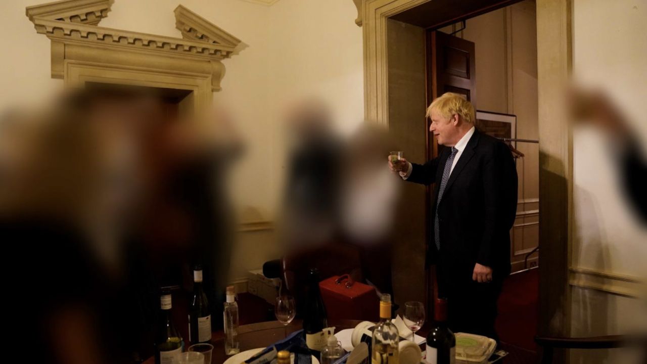Johnson raising a glass during one of the Downing Street gatherings, in a picture released during a seperate investigation into his conduct.