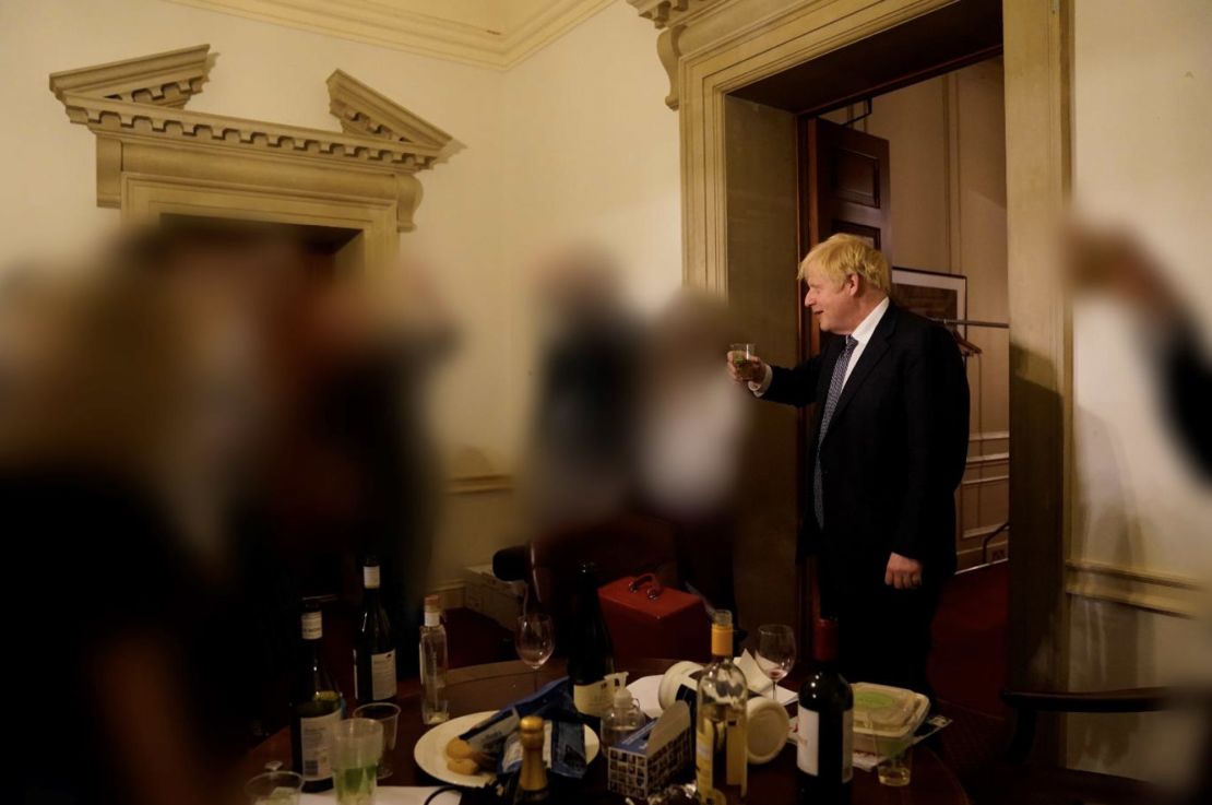Johnson raising a glass during one of the Downing Street gatherings, in a picture released during a seperate investigation into his conduct.