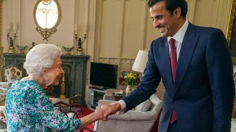 Britain's Queen Elizabeth II shakes hands with the Emir of Qatar Sheikh Tamim bin Hamad al-Thani during an audience at Windsor Castle, west of London on Tuesday. Britain said it had agreed a new investment partnership with Qatar on Tuesday which will see the Gulf state invest up to 10 billion pounds ($12.5 billion) in the next five years. 