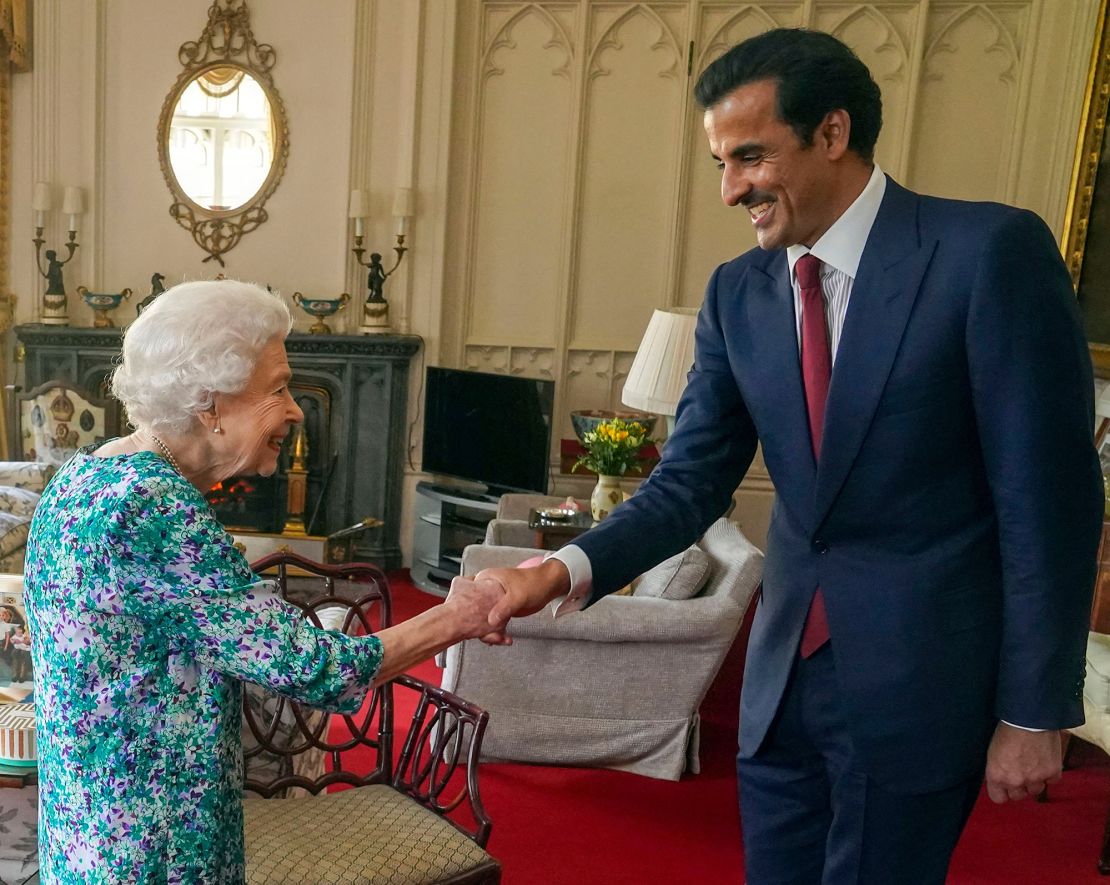 Britain's Queen Elizabeth II shakes hands with the Emir of Qatar Sheikh Tamim bin Hamad al-Thani during an audience at Windsor Castle, west of London on Tuesday. Britain said it had agreed a new investment partnership with Qatar on Tuesday which will see the Gulf state invest up to 10 billion pounds ($12.5 billion) in the next five years.
