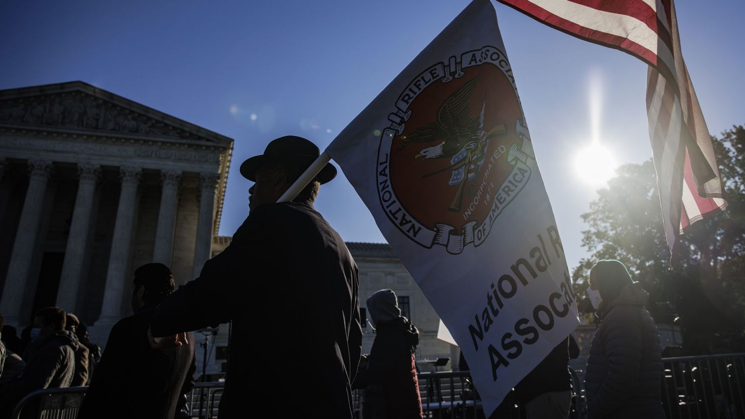 A demonstrator holds American and National Rifle Association flags outside the Supreme Court in November 2021.