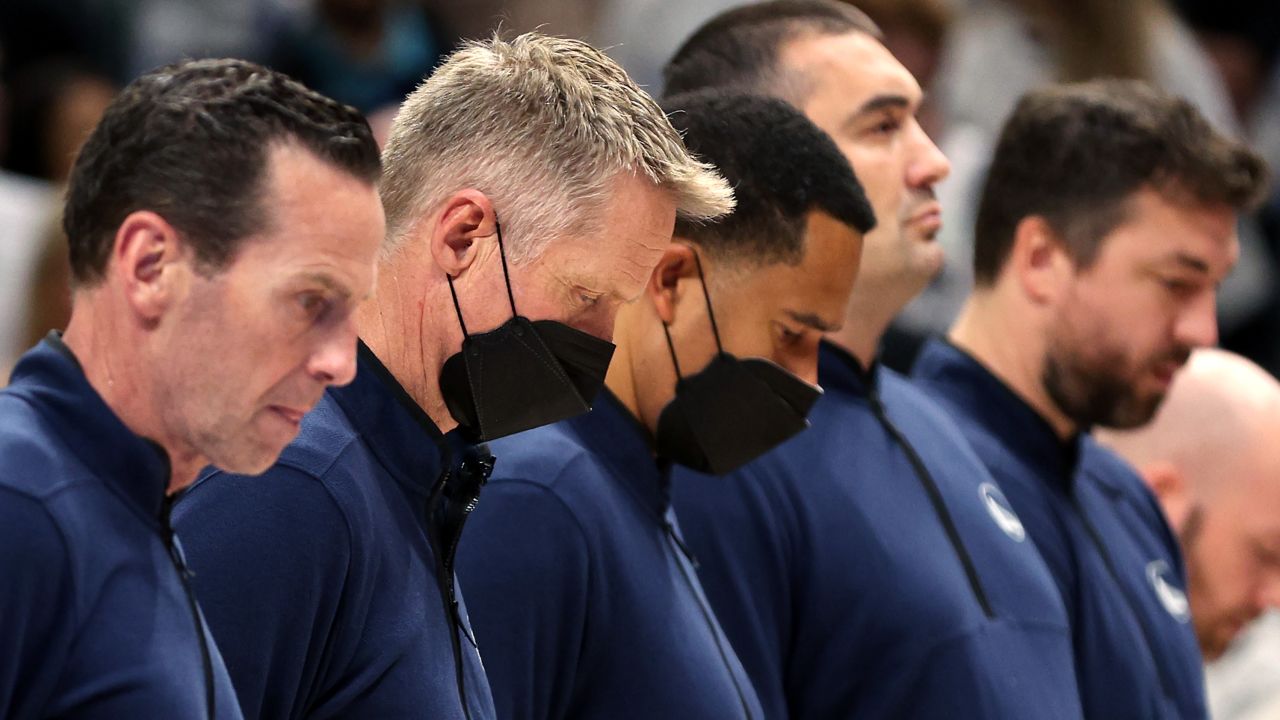 Kerr stands for a moment of silence following Tuesday's mass shooting.
