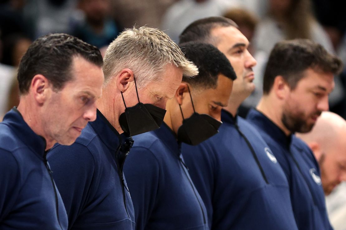Kerr stands for a moment of silence following Tuesday's mass shooting.