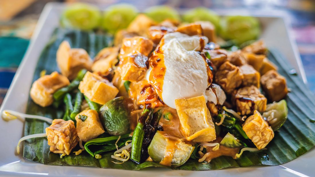 <strong>Gado gado, Indonesia: </strong>Meaning "mix-mix," gado gado tosses together a garden of vegetables and tasty ingredients in a thick, peanutty sauce. These can often include green beans, cabbage, carrots, bean sprouts, lettuce, tofu, cucumbers, tempeh, potatoes and egg.