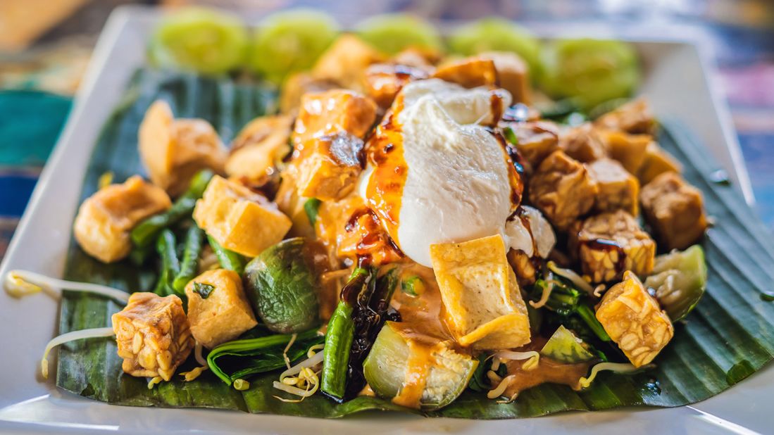 <strong>Gado gado, Indonesia: </strong>Meaning "mix-mix,"  gado gado tosses together a garden of vegetables and tasty ingredients in a thick, peanutty sauce. These can often include green beans, cabbage, carrots, bean sprouts, lettuce, tofu, cucumbers, tempeh, potatoes and egg. 