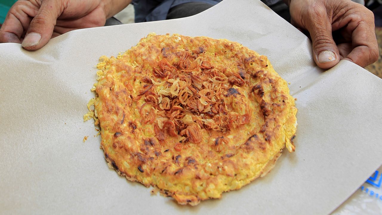 <strong>Kerak telor, Indonesia: </strong>Cooked over charcoal, kerak telor (meaning "egg crust") is a traditional Betawi dish that bursts with flavor and texture thanks to ingredients like duck eggs, glutinous rice, grated coconut, fried shallots, dried shrimp and Indonesian spices. 