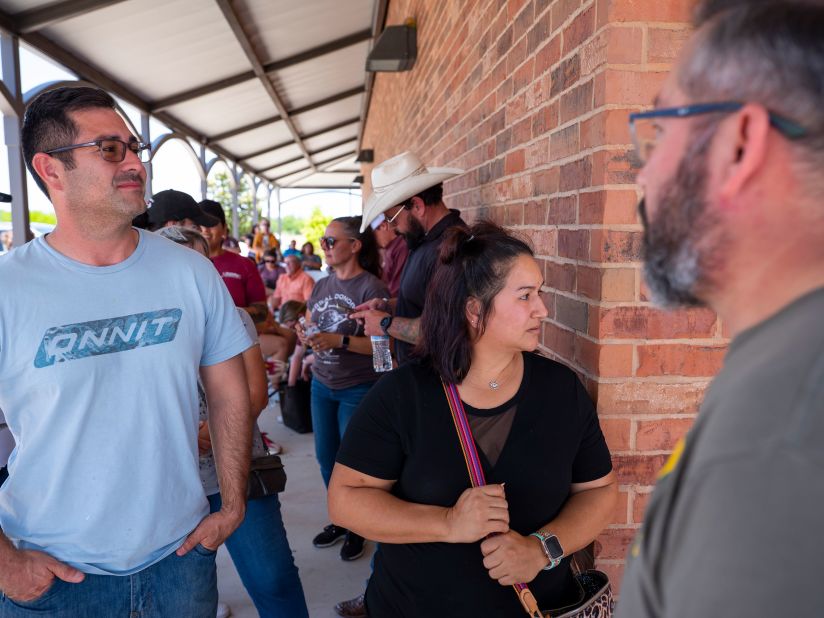 From left, Michael Cavasos, Brenda Perez and Eduardo Galindo are seen in the foreground as they wait in line to donate blood in Uvalde on May 25. Galindo, who lives in Uvalde, said: "When it hits you in your hometown, you wake up and say, 'Wow.' ... We have to be here and show support for these families right now." Approximately 200 people donated blood to South Texas Blood and Tissue, who would be delivering the units to surrounding area hospitals.