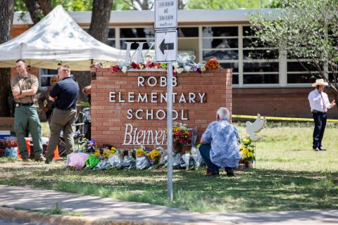 Flowers are seen at the memorial in front of the school on Wednesday.