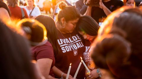 Attendees light candles during a memorial held for the 19 children and two teachers who were murdered by an 18-year-old gunman at Robb Elementary School.