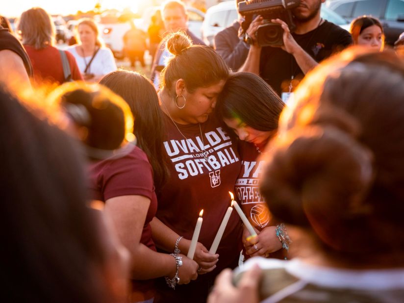 People in Uvalde light candles during a memorial for the shooting victims on May 25.