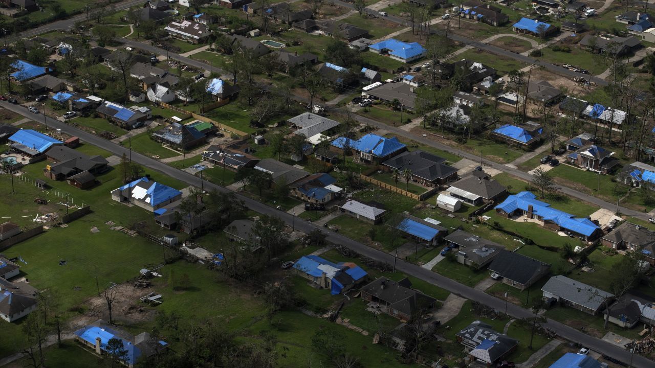Blue tarps cover the roofs of homes after multiple hurricanes hit Lake Charles in 2020. Corbani says there are homes and businesses still with blue tarps today.