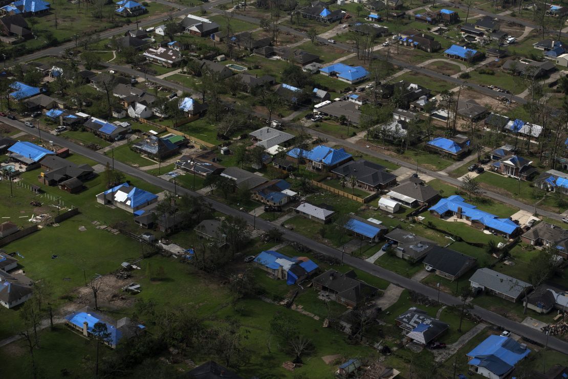 Blue tarps cover the roofs of homes after multiple hurricanes hit Lake Charles in 2020. Corbani says there are homes and businesses still with blue tarps today.