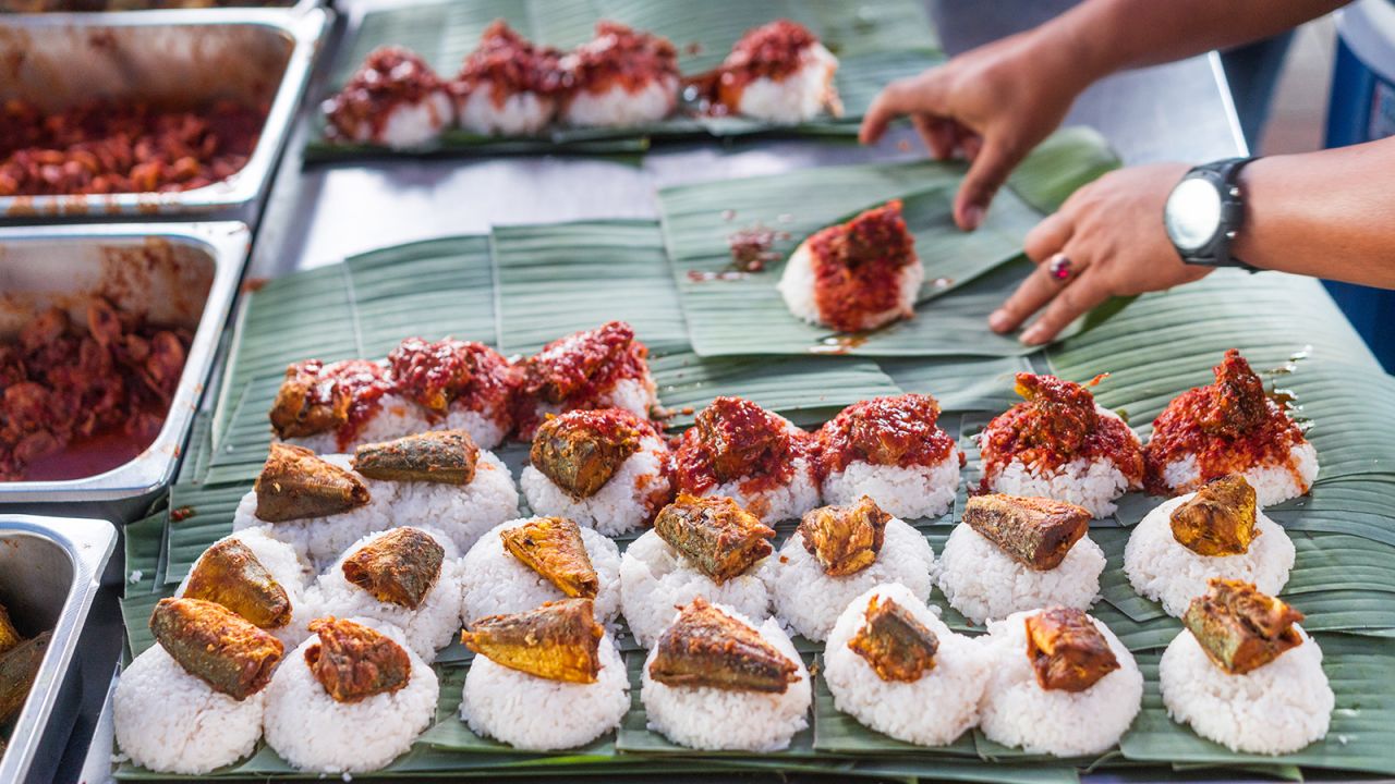<strong>Nasi lemak, Malaysia: </strong>This treat tantalizes taste buds with a bed of coconut rice topped with salty anchovies, roasted peanuts, boiled eggs, cucumbers and sambal served hot and steamy in a fragrant banana leaf.