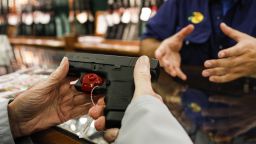 A shopper browses a handheld firearm for sale inside a Bass Pro Outdoor World LLC store on Black Friday in Tampa, Florida, U.S., on Friday, Nov. 23, 2018. Deloitte expects sales from November to January to rise as much as 5.6 percent, to more than $1.1 trillion, marking the best holiday period in recent memory. Photographer: Eve Edelheit/Bloomberg via Getty Images