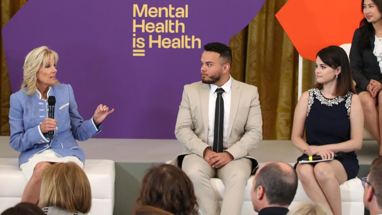 First lady Jill Biden speaks on stage while Selena Gomez looks on MTV Entertainment hosts first ever Mental Health Youth Forum at the White House on May 18, 2022.