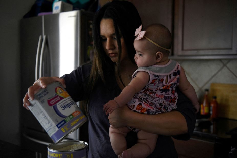 Kim Anatra holds her 5-month-old daughter, Sienna, while pouring leftover baby formula into her last jar in Houston on Thursday, May 19. For months, stores nationwide <a href="https://www.cnn.com/2022/05/25/health/formula-supply/index.html" target="_blank">have been struggling to stock enough formula.</a>