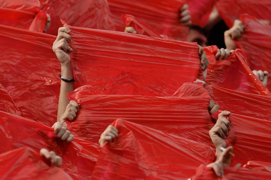 Fans of the Italian soccer club AC Milan hold plastic sheets as part of a huge tifo display before a match in Sassuolo on Monday, May 22.