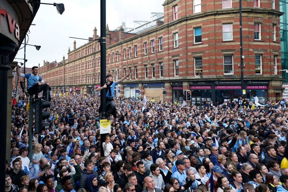 Manchester City fans gather to watch the soccer club's victory parade in Manchester, England, on Monday, May 23. City clinched its second-straight Premier League title — and its fourth in five years — with a <a href="https://www.cnn.com/2022/05/22/football/manchester-city-aston-villa-premier-league-spt-intl/index.html" target="_blank">thrilling comeback win over Aston Villa</a> on Sunday.
