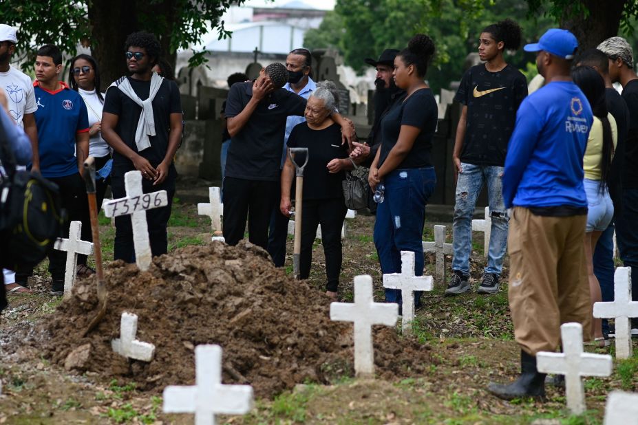 Divone Ferreira, center, is accompanied by relatives and friends during the funeral for her daughter, Gabrielle Ferreira da Cunha, in Rio de Janeiro on Wednesday, May 25. Gabrielle, 41, was killed by a stray bullet in her house during a police operation in a neighboring favela.