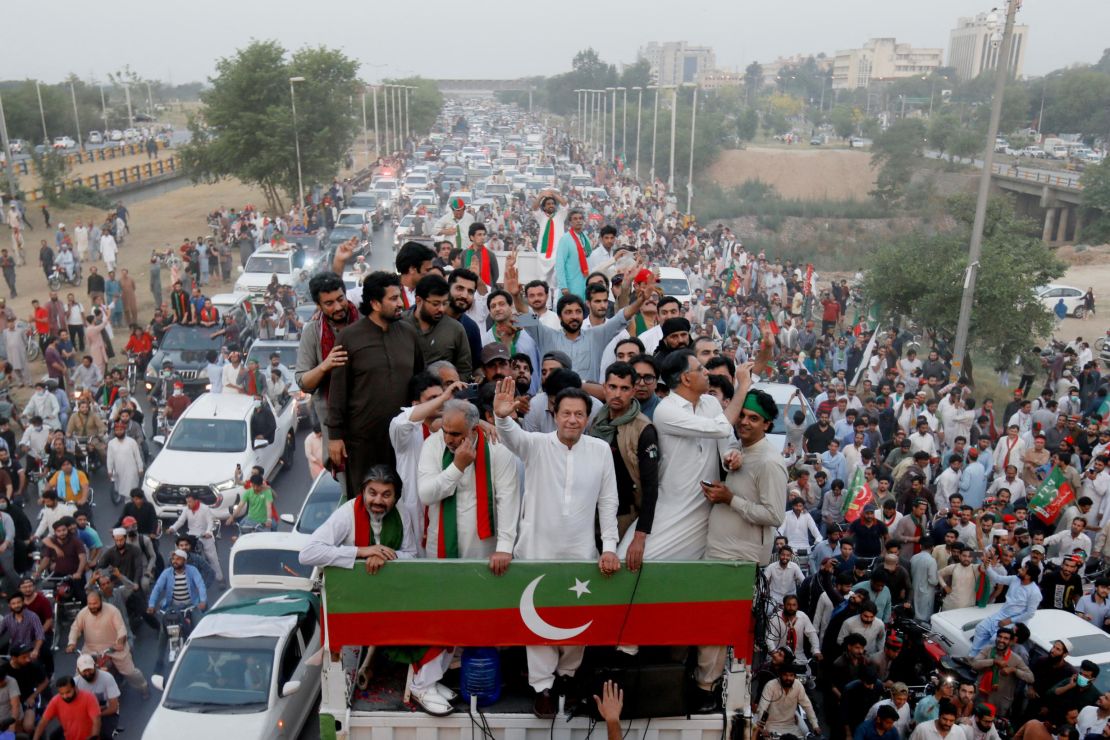 Former Pakistani Prime Minister Imran Khan gestures as he travels on a vehicle to lead a protest march in Islamabad, Pakistan on May 26, 2022. 