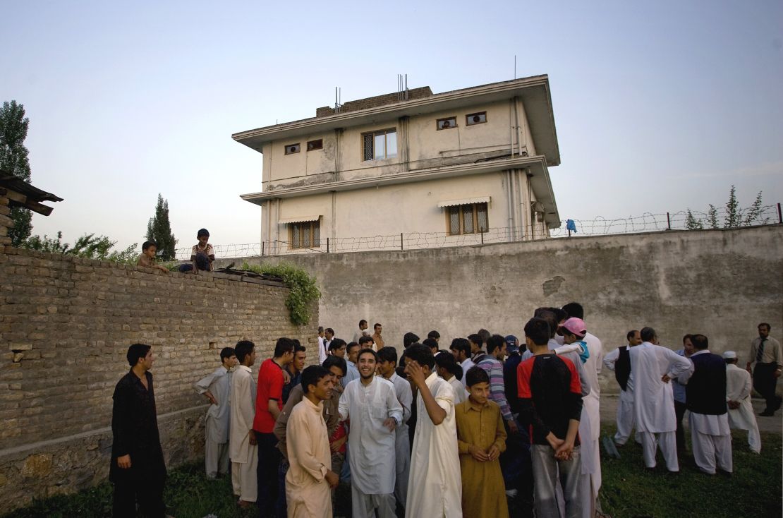 Residents gather outside a house, where al Qaeda leader Osama bin Laden was caught and killed in Abbottabad, Pakistan on May 3, 2011.
