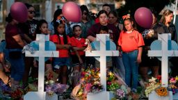 People gather at a memorial site to pay their respects for the victims killed in this week's elementary school shooting in Uvalde, Texas, Thursday, May 26, 2022. (AP Photo/Jae C. Hong)