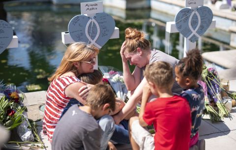 The friends and family of Miranda Mathis, one of the young victims of the school shooting in Uvalde, Texas, grieve her loss in front of a cross bearing her name on Thursday, May 26. 
