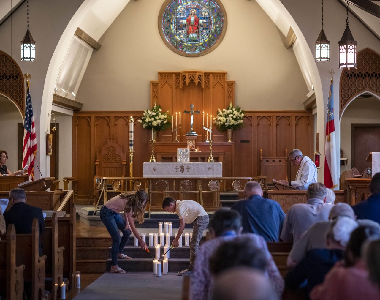 Congregants at St. Philip's Episcopal Church light candles in Uvalde to remember the shooting victims on May 26.