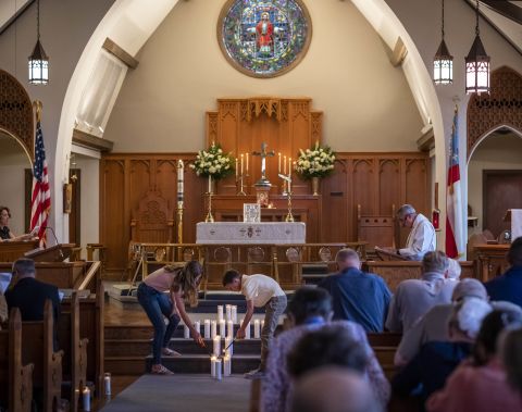 Congregants at St. Philip's Episcopal Church light candles in Uvalde to remember the shooting victims on Thursday.
