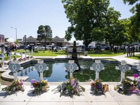 Crosses bear the names of shooting victims on Thursday.