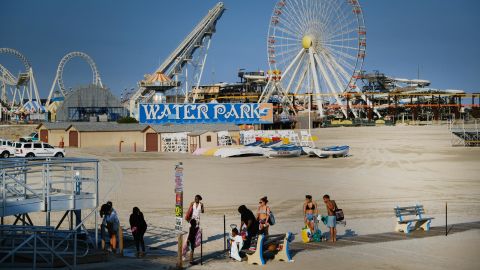 WILDWOOD, NEW JERSEY - MAY 27: People walk along the beach days before the Memorial Day weekend, the un-official start of summer, on the Jersey shore on May 27, 2021 in Wildwood, New Jersey. Wildwood, like many beach communities throughout the United States, is looking for a successful and busy summer season after staying mostly closed or partially open last summer due to Covid-19 restrictions. Many resort community retail businesses are also suffering from a shortage of labor as some workers are choosing to stay home and others have changed career paths.  (Photo by Spencer Platt/Getty Images)