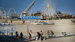 WILDWOOD, NEW JERSEY - MAY 27: People walk along the beach days before the Memorial Day weekend, the un-official start of summer, on the Jersey shore on May 27, 2021 in Wildwood, New Jersey. Wildwood, like many beach communities throughout the United States, is looking for a successful and busy summer season after staying mostly closed or partially open last summer due to Covid-19 restrictions. Many resort community retail businesses are also suffering from a shortage of labor as some workers are choosing to stay home and others have changed career paths. (Photo by Spencer Platt/Getty Images)