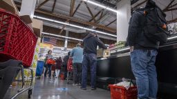 Shoppers wait in line to checkout inside a grocery store in San Francisco, California, U.S., on Monday, May 2, 2022. 